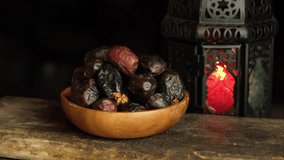 Date fruits on wooden table. Selective focus. Panning to the right.