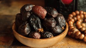 Dried date fruits on wooden board. Selective focus. Tracking shot.