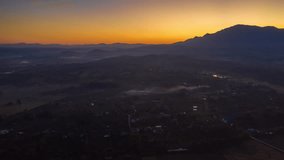 motion timelapse hyperlapse aerial scene fly over rural city and mountain in day time light morning 4k video