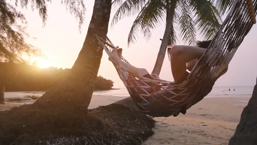 Tropical getaway, tourist relaxing in beach hammock, exotic retreat | Shutterstock HD Video #1024326530