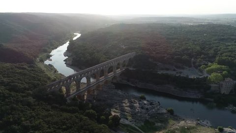 Aerial view of Pont du Gard is ancient Roman aqueduct that crosses the Gardon River near the towns of Remoulins Avignon and Nimes in southern France and is on UNESCO's list of World Heritage Sites 4k