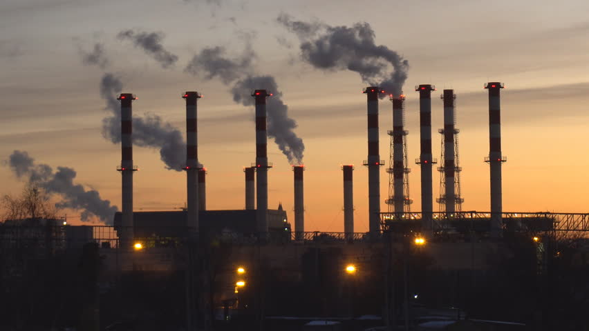 Industrial landscape, the pipes of the thermal power plant at sunset