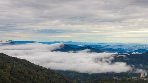 Beautiful View Of Fast Rolling Clouds Drifting Over mountains and hills. Soft Focus, Timelapse. Pahang, Malaysia. Pan down motion timelapse.