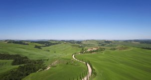 Amazing Italy aerial landscape, typical tuscany aerial landscape. Aerial video over amazing Tuscany landscape, with winding road with cypresses. 