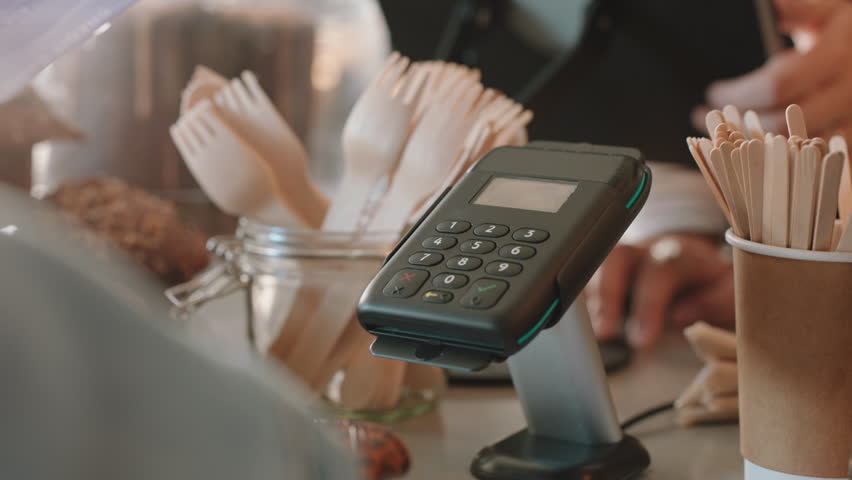 Close up customer paying using credit card contactless payment spending money in cafe with digital transaction service | Shutterstock HD Video #1024354517