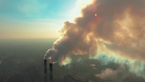 Aerial view. Emission to atmosphere from industrial pipes. Smokestack pipes shooted with drone