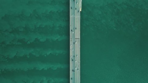 Aerial Top View of a Highway Bridge Flying Towards Traffic Over Sea Ocean in Penang Malaysia