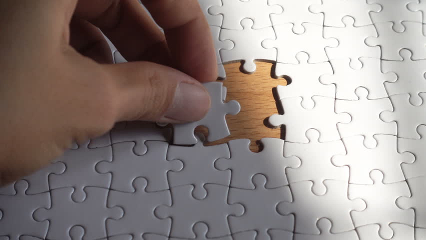 Woman hand putting the last piece in the puzzle
 | Shutterstock HD Video #1024378634