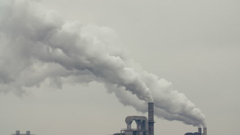 Industry air pollution 4k footage: Factory chimney is spouting volumes of dense smoke into the sky, thick white smoke is poured from the factory pipe.concept of environment protection.