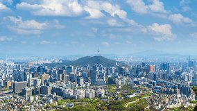 Time lapse of Cityscape in Seoul with Seoul tower and blue sky, South Korea. Zoom out