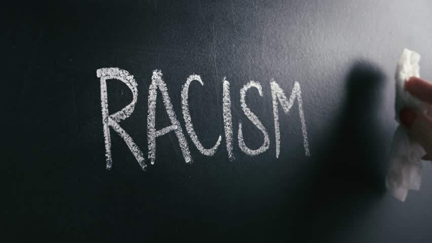 Racism concept. Stop hate and discrimination. Against prejudice and violence. Hand wiping off and erasing the word from blackboard. Royalty-Free Stock Footage #1024392227