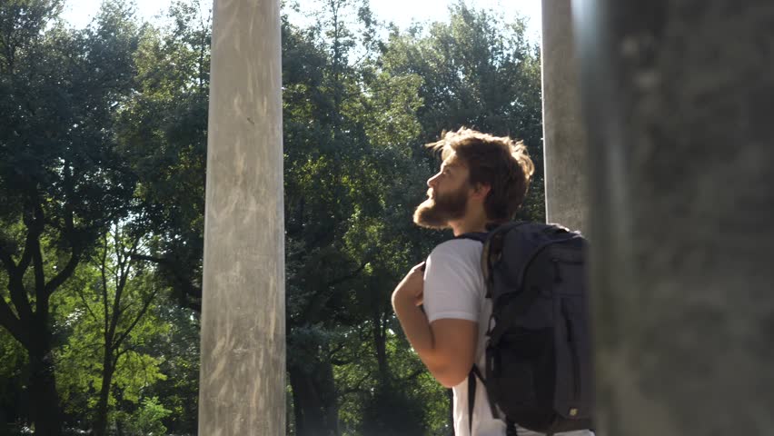 Young Tourist Looking Up In Wonder At Monument.
