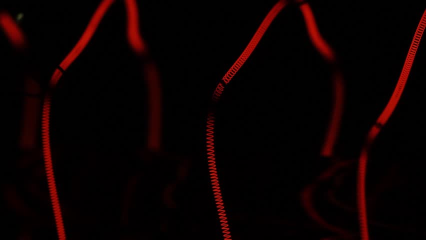Incandescent bulbs in yellow and red as an artificial light source. Triple helix with conductors and holders (enlarged). macro video close up | Shutterstock HD Video #1024398467