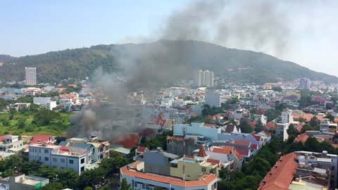 VUNG TAU, VIETNAM - JANUARY 27, 2019: High angle shot of dense smoke rising from a house under the fire in the city centre.