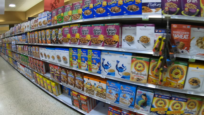 HOLLYWOOD, FLORIDA / USA - JUNE 2018: Supermarket in Florida, United States of America. American shop with boxes of breakfast cereals, cookies, biscuits, snacks on shelf. POV of customer walking