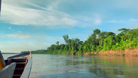 Slow motion shot of a wooden speed boat traveling on Amazon river. Amazon, jungle, rainforest. Peru.