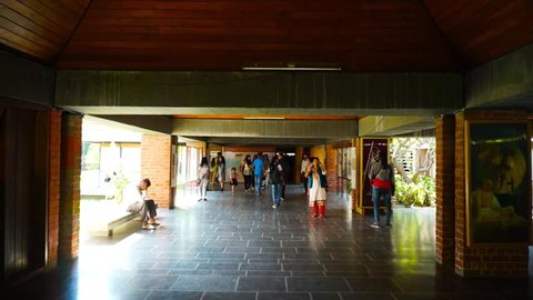Ahmedabad, Gujarat, India - Circa 2018: Visitors to the halls of the sabarmati ashram in Gujarat India, which has multiple exhibits of how Mahatma Gandhi lived, his belongings and lifestyle. This