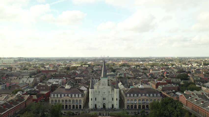 Drone descends to show St Louis Cathedral with backdrop of the French Quarter in New Orleans