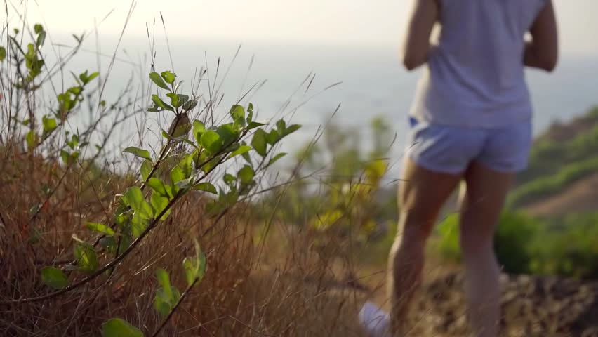 Woman walking in nature on vacation, hill hike.