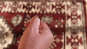 Close up vie of a Muslim man hand counting prayer beads or tasbih on a prayer mat. Selective focus. Panning shot.
