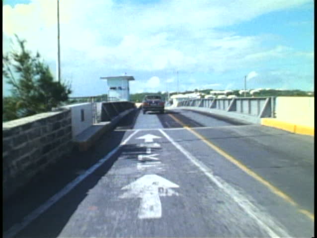 HAMILTON, BERMUDA, 1994, POV from moped on a long bridge in Bermuda
