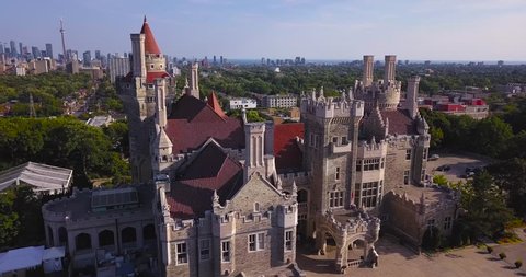 Aerial Daytime Medium Wide Shot Orbiting Counterclockwise Around Casa Loma Castle House In Summer Sunshine With Downtown City Skyline Background In Toronto Ontario Canada