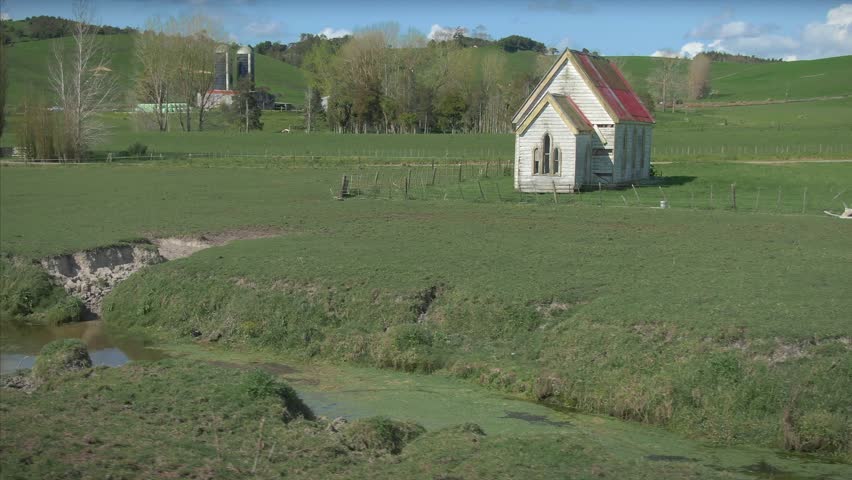 Aerial: old Ratana church in a state of disrepair on farmland in Ruawai near Dargaville. Northland, New Zealand 