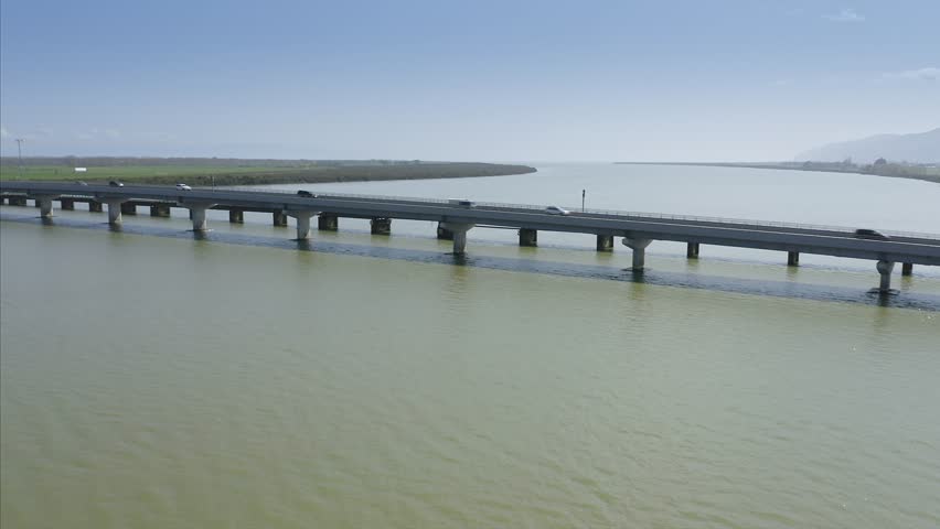 Aerial: Flying over the Thames river & Kopu Bridge in the gateway to Coromandel peninsula, New Zealand  