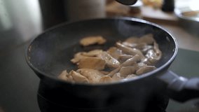Closeup of food being cooked in fried pan (slow motion)