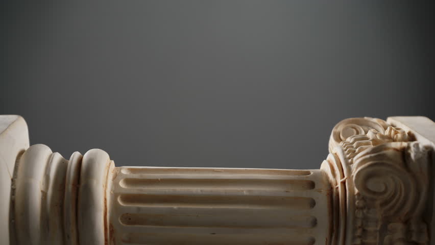 Single ancient corinthian column on dark grey background with light effect