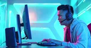 Profile of Young Asian Handsome Pro Gamer Playing in Online Video Game