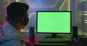 Young Asian Pro Gamer show green chroma key screen computer