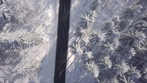 Sunny Aerial View snowy road in Winter Forest Germany
