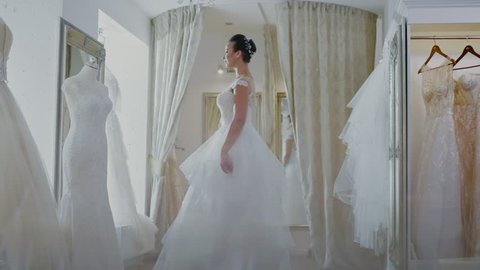 Beautifu bride choosing wedding dress in a wedding salon 库存视频