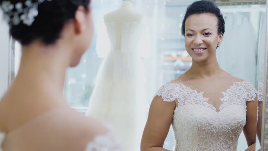 Beautifu bride choosing wedding dress in a wedding salon
