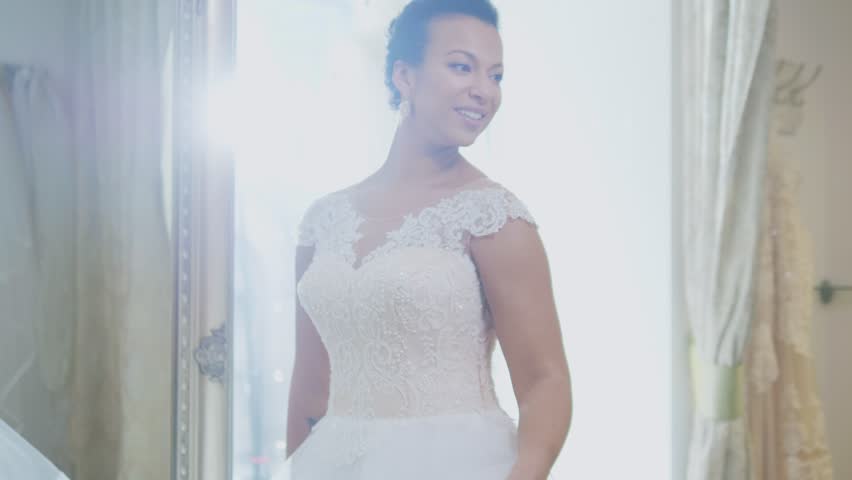 Beautifu bride choosing wedding dress in a wedding salon