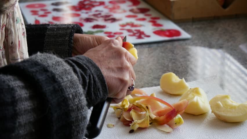 close up of woman peeling an apple