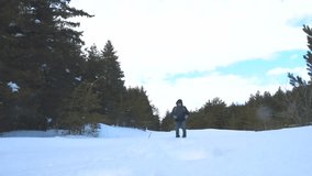human feet go in deep snow. slow motion video. man traveler with backpack walks in the snow forest winter. overcoming lifestyle difficulties concept problems difficult path to success concept travel
