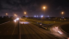 Looking Down from the Overpass of the Florida Turnpike in Pompano Beach, Florida at Night including the On and Off-Ramps with Cars Creating Short Streaks in a Slow Shutter-Speed Time-Lapse