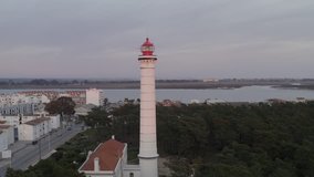 Aerial drone video of Vila Real de Santo António city, lighthouse farol and stadium in Portugal, at sunset