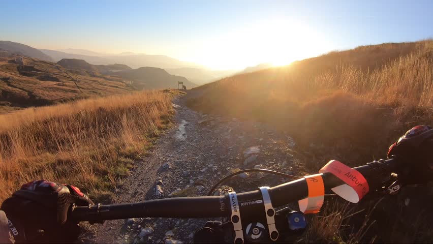 Onboard camera: Mountain biking downhill in stone road in Slate Mountain, Great Britain. View from first person perspective POV. 50 fps Royalty-Free Stock Footage #1024490909