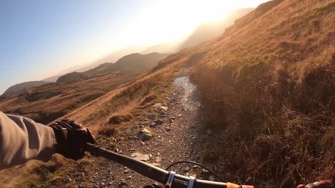 Onboard camera: Mountain biking downhill in stone road in Slate Mountain, Great Britain. View from first person perspective POV. 50 fps