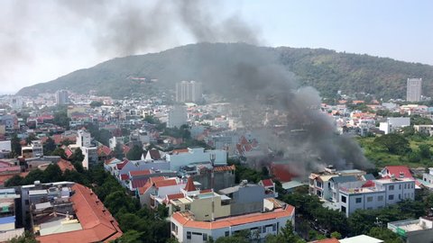 VUNG TAU, VIETNAM - JANUARY 27, 2019: High angle shot of dense smoke rising from a house under the fire in the city centre.
