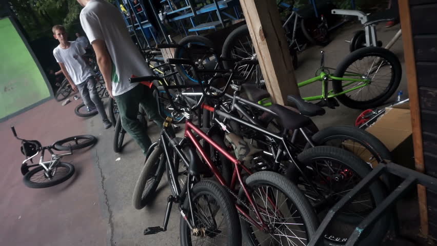 Many bicycles lies beside the stands at cycling competitions slow motion