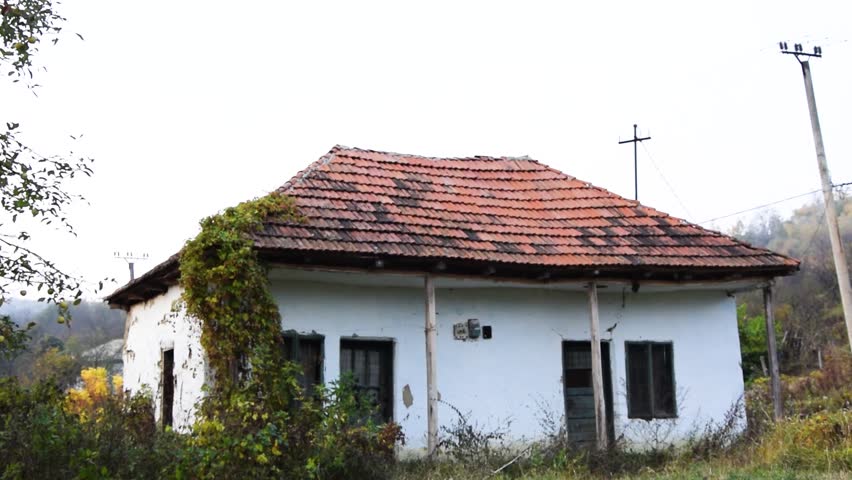 Tilt down of old abandoned house from rural area in Romania