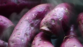 Sweet potatoes are hot steamed cooked footage slow motion