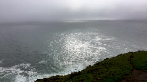 Scenic wide view of Bodega Bay overlooking the rough waves in the ocean, slow motion