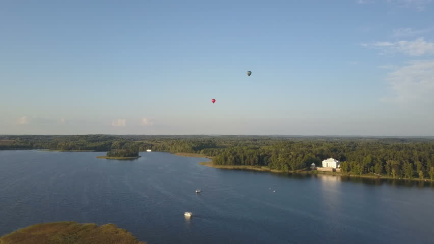 Aerial view of beautiful Trakai castle at sunset in summer season. Hot air balloons over lakes and castle in Lithuania.