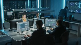 Team of IT Programers Working on Desktop Computers in Data Center Control Room. Young Professionals Writing on Sophisticated Programming Code Language. Elevated Moving Camera Shot - Powered by Shutterstock - Get 15% off with code: PIKWIZARD15
