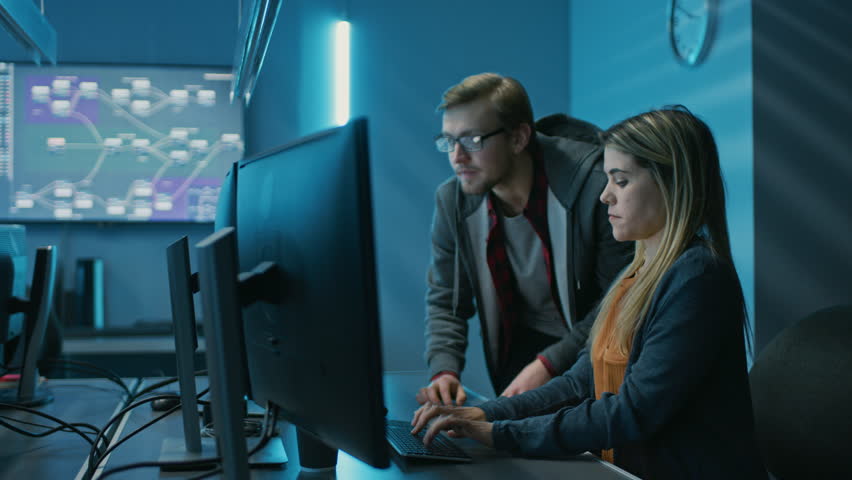 Male and Female Programmers Talking about Work, Solving Problems Together, Using Computers. Software Development / Code Writing / Website Design / Database Architecture.  Royalty-Free Stock Footage #1024519571